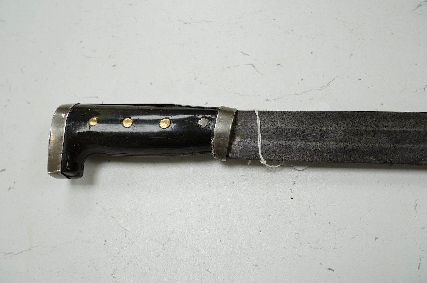 A Mexican sword machete, broad blade cut with a single fuller, with silver mounted horn hilt, blade 81cm. Condition - good